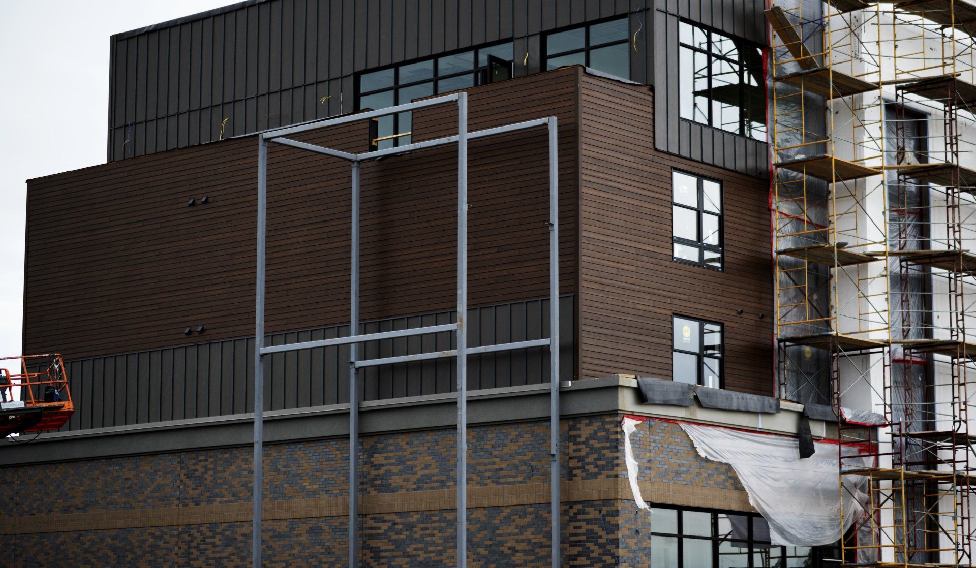 a large brick building is being built with scaffolding around it .