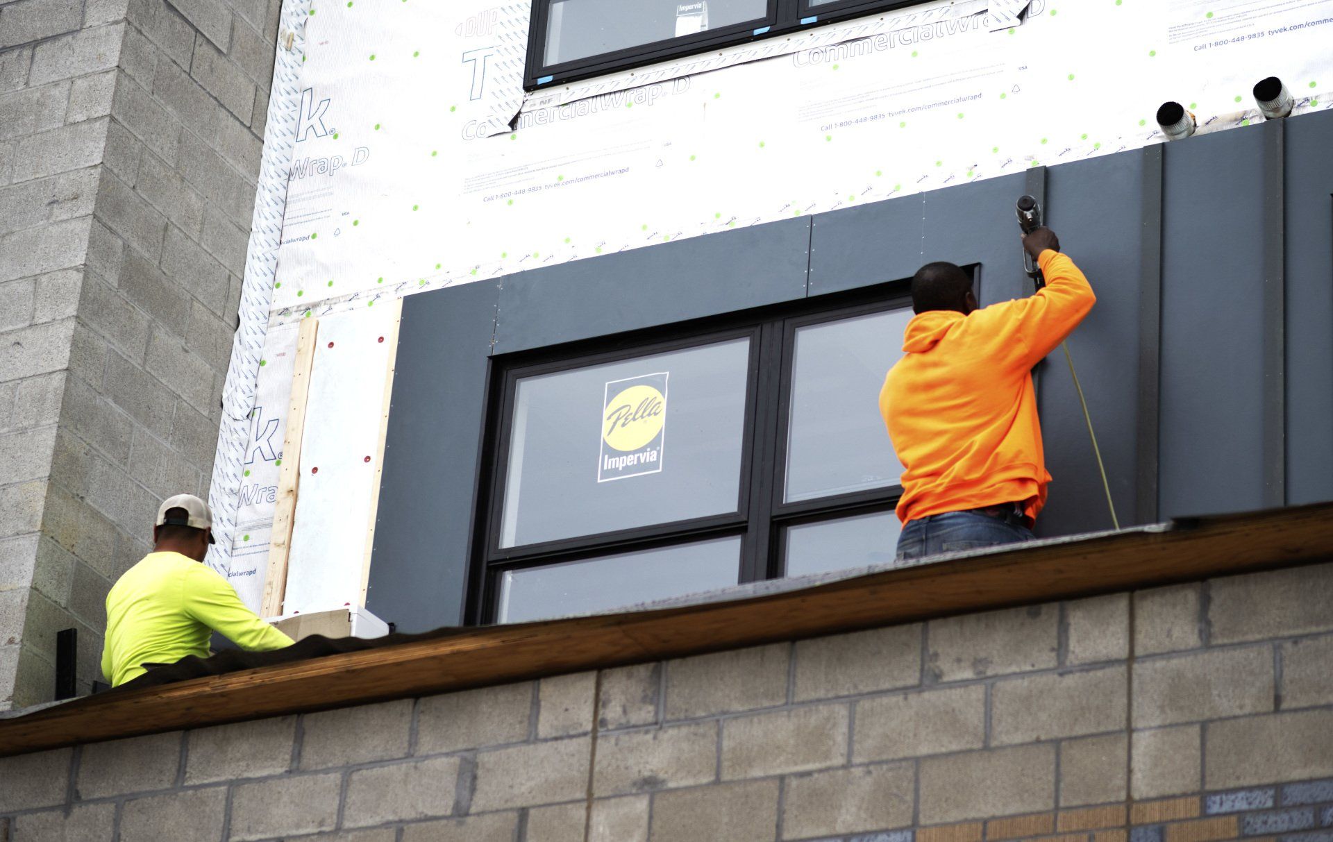 person working on building exterior