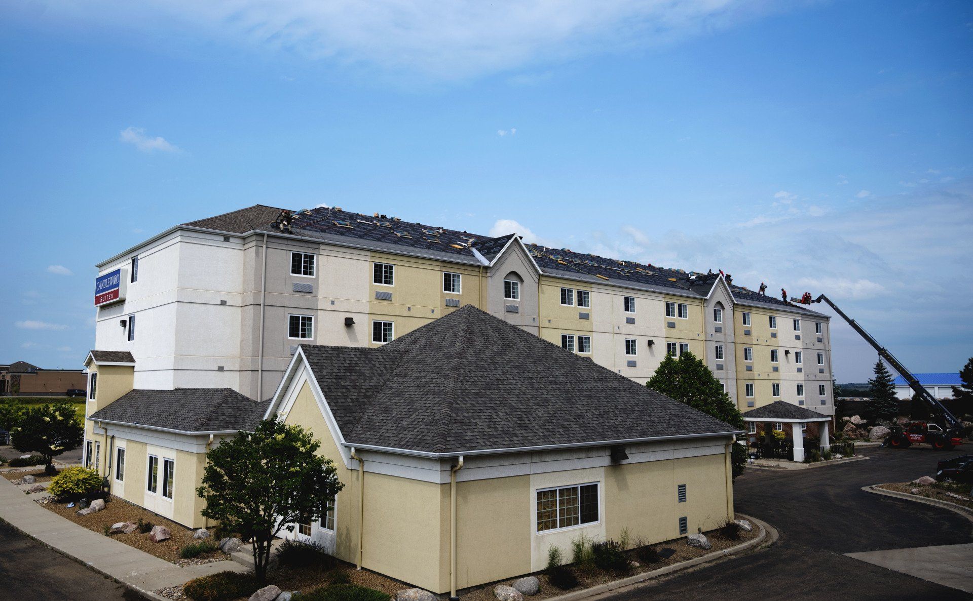 a large yellow and white building with a gray roof