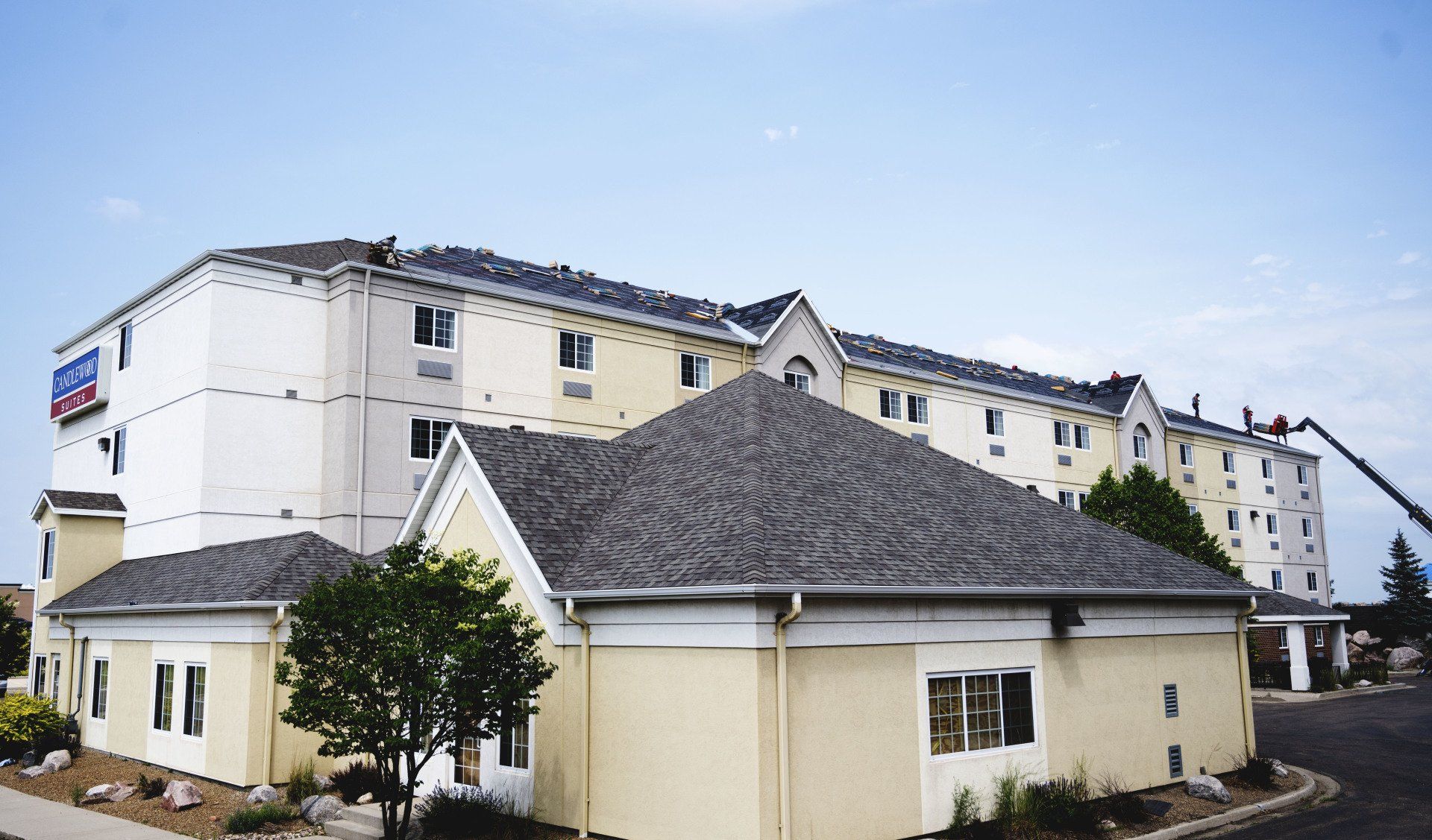 a large yellow and white building with a gray roof