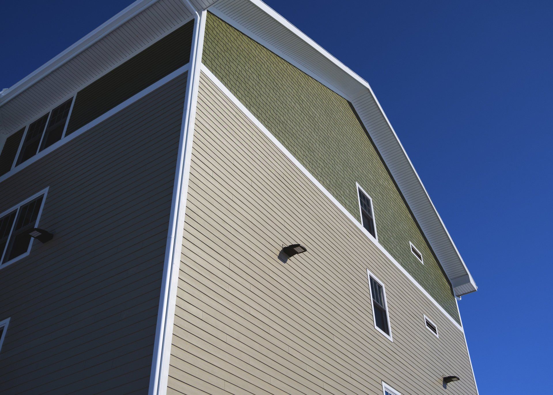 looking up at a building with a blue sky in the background