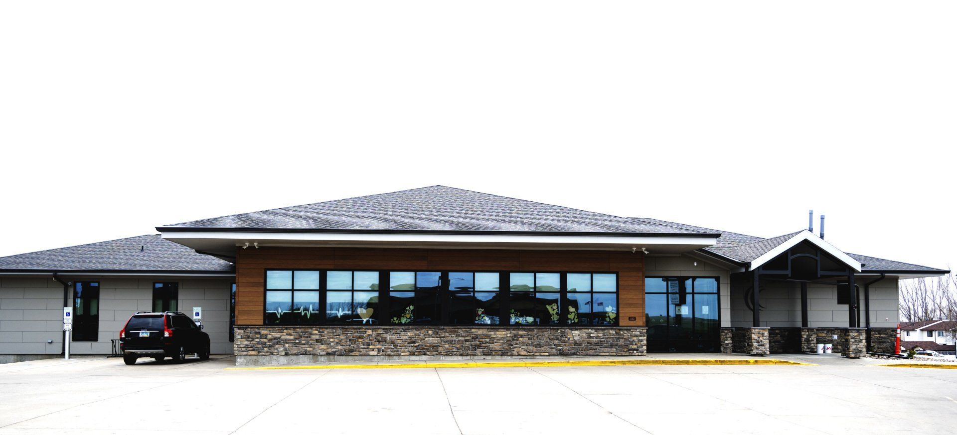 a car is parked in front of a large building .