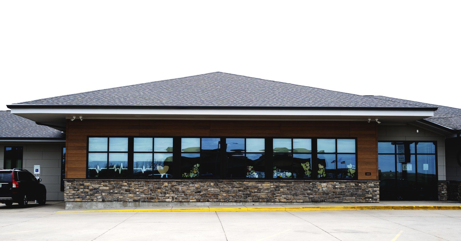 a large building with a lot of windows and a car parked in front of it .