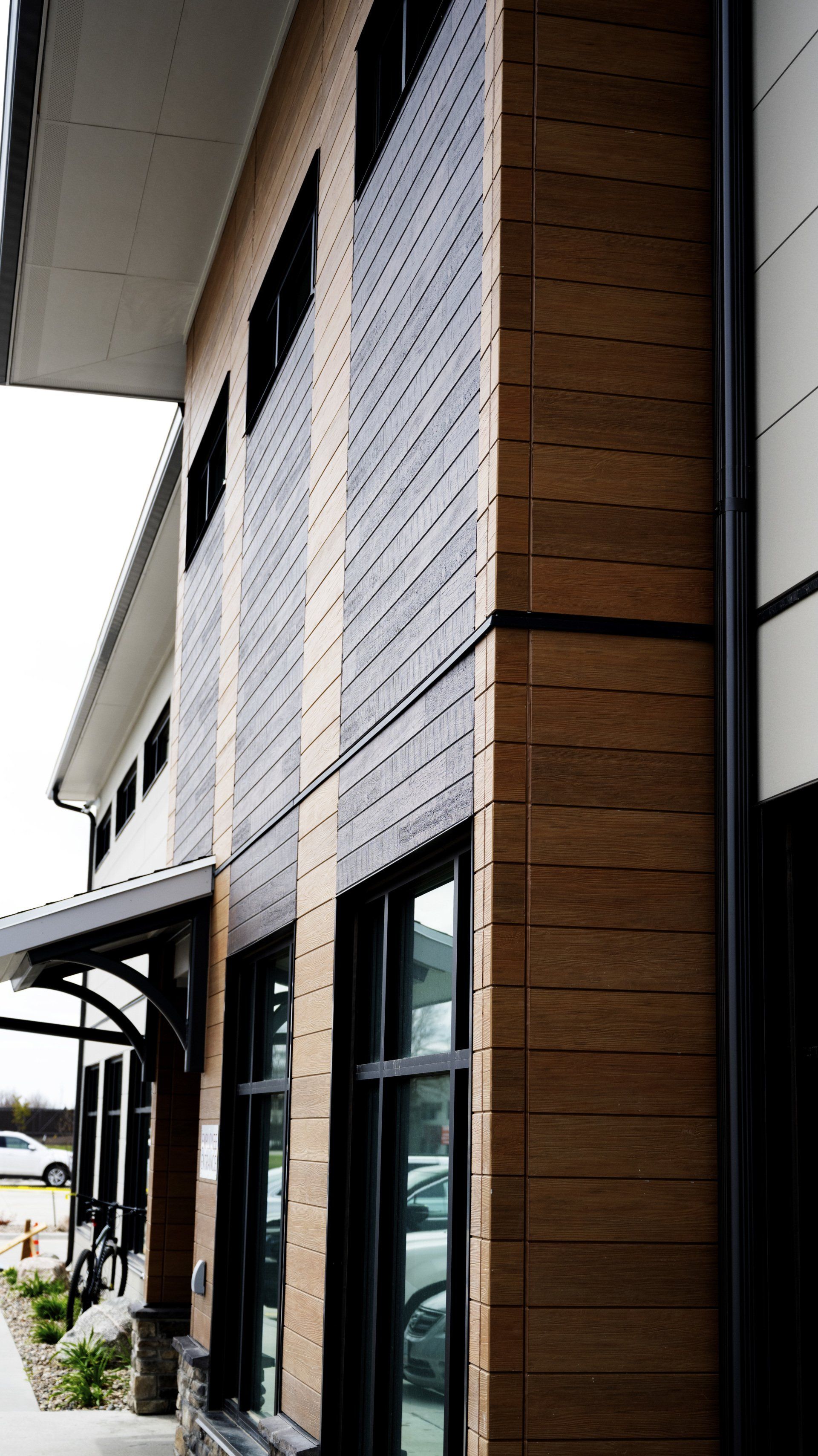 a building with a lot of windows and a wooden facade .