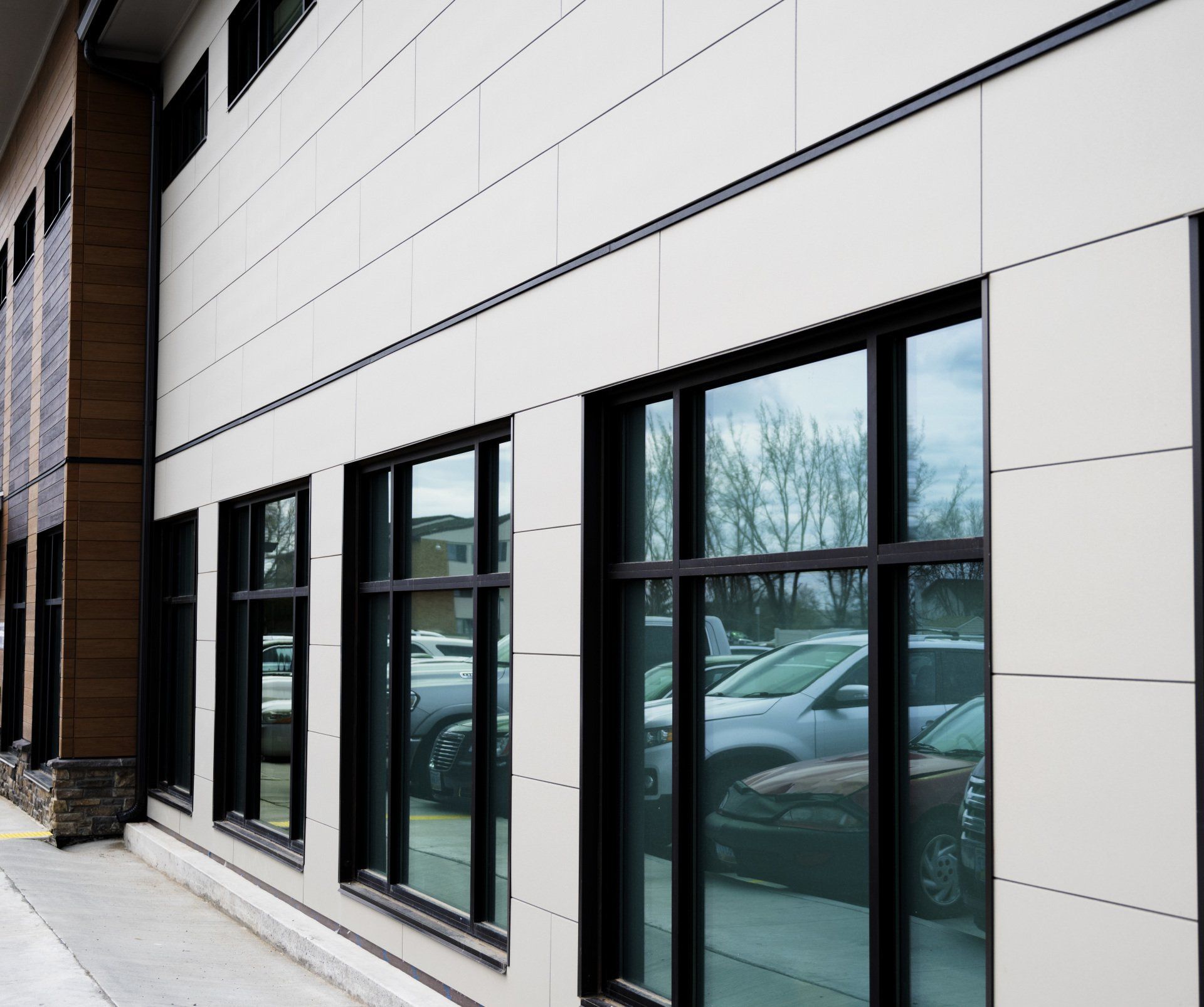 a building with a lot of windows and cars parked in front of it