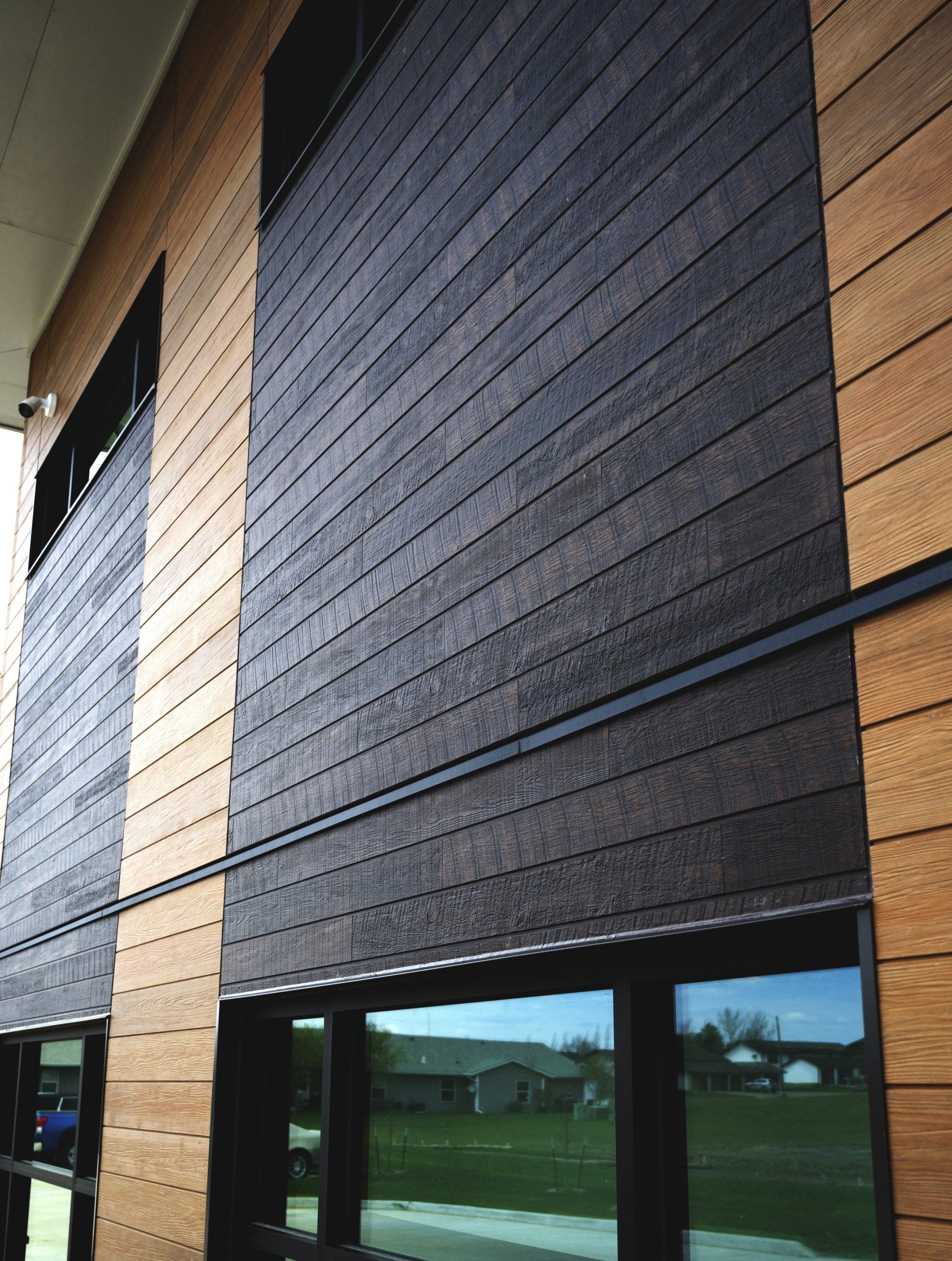 a building with a lot of windows and a wooden facade