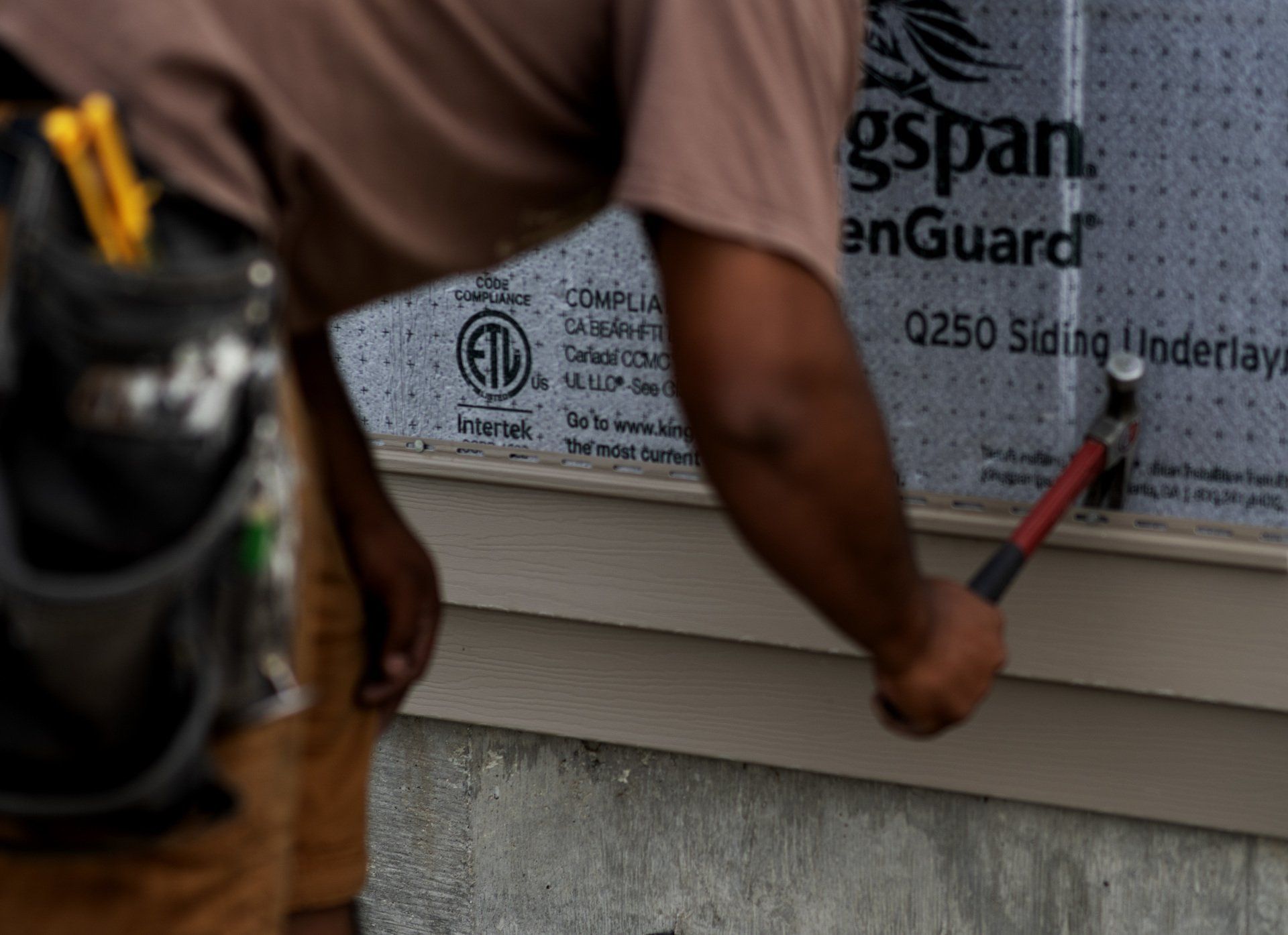 person working on siding