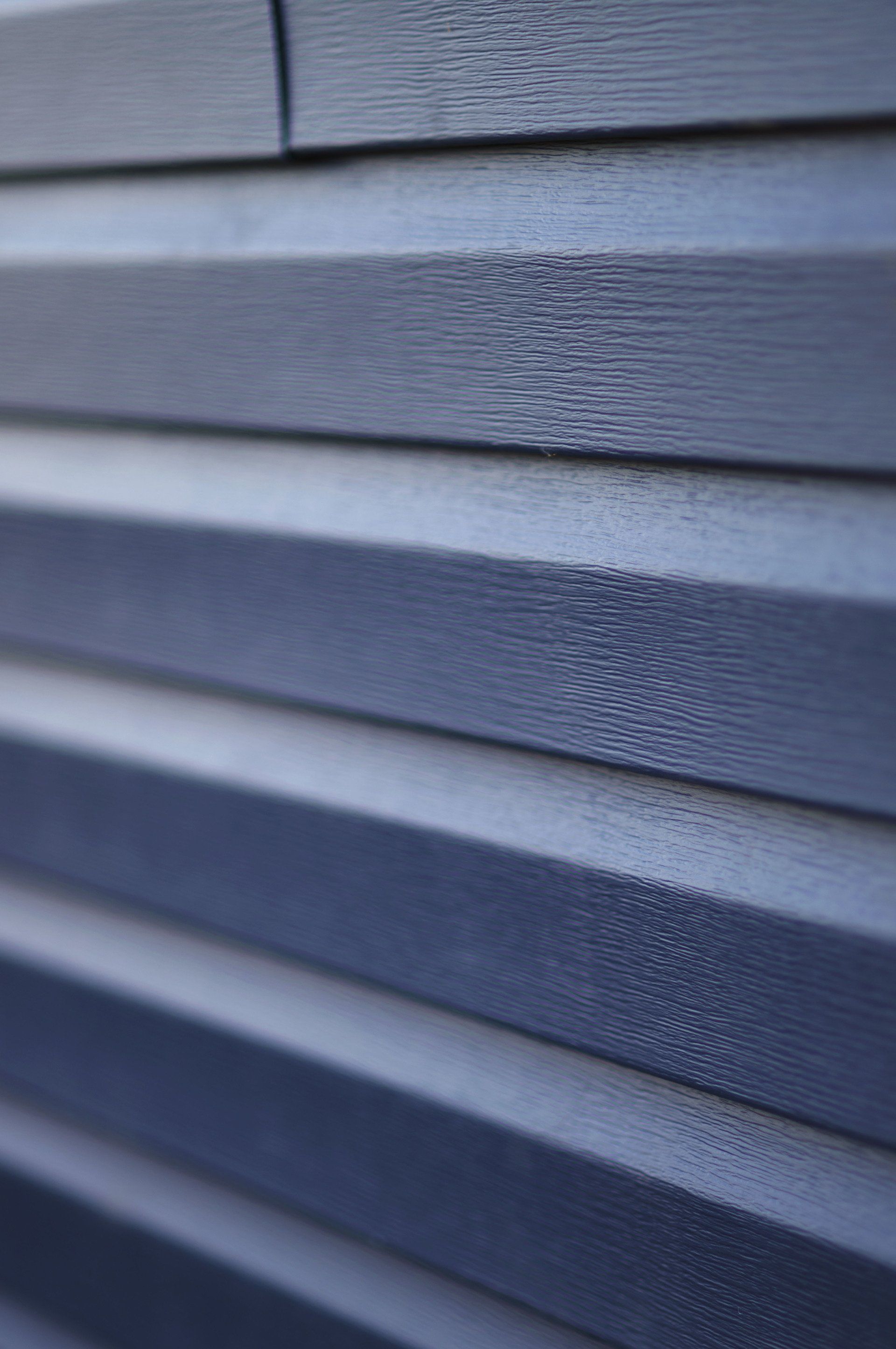 a close up of a blue siding on a house .