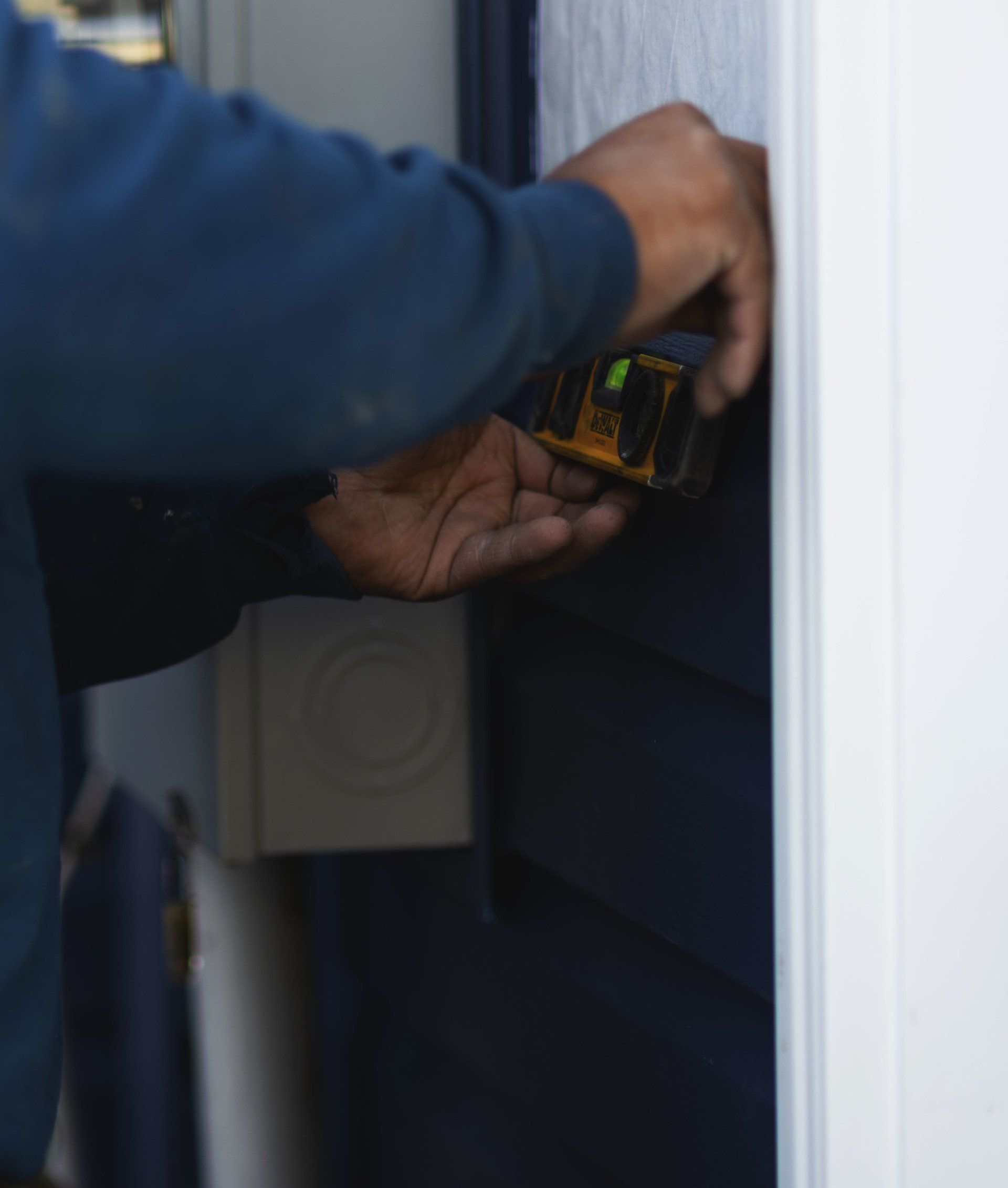 a man is measuring a door with a tape measure
