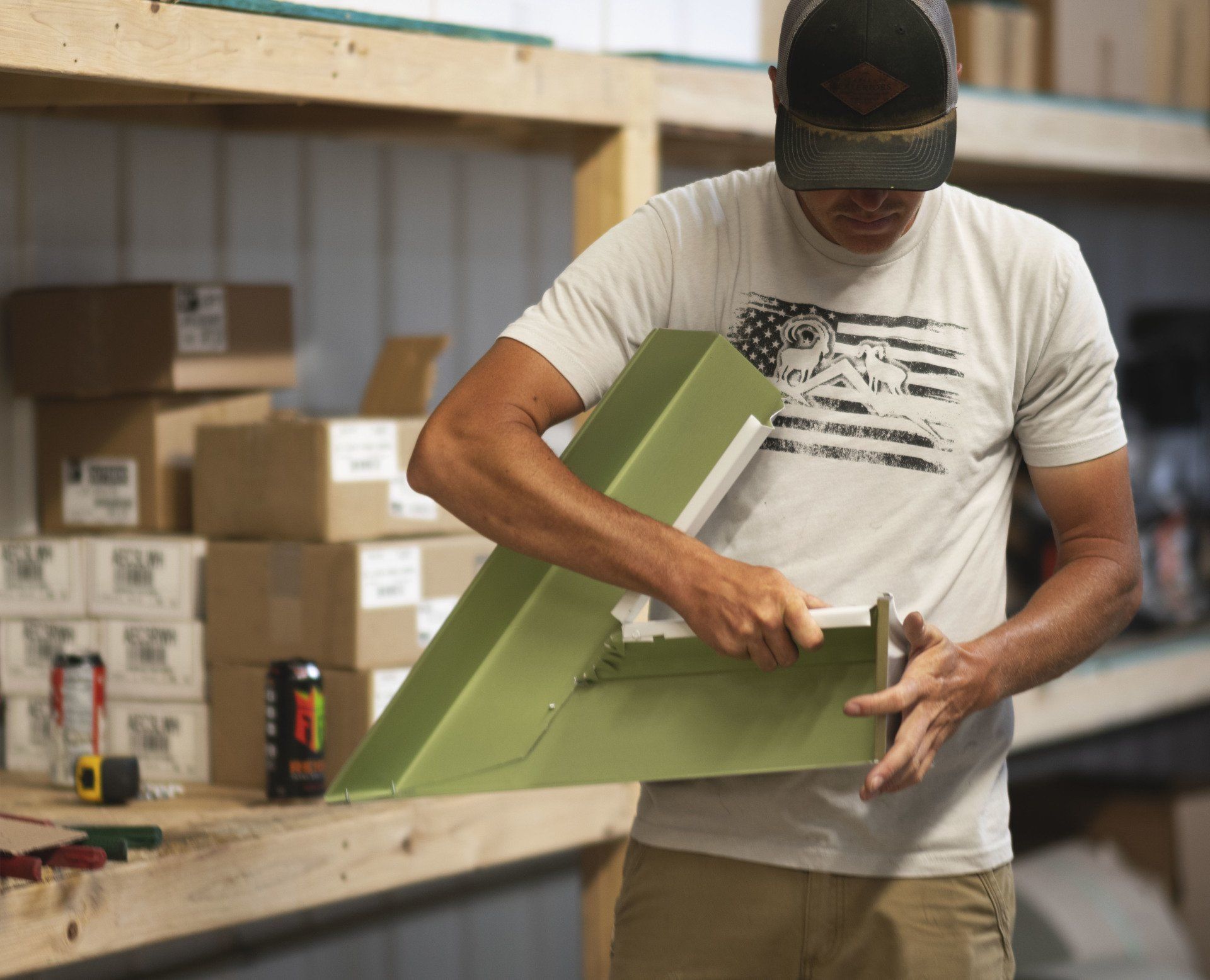 a man wearing an american flag shirt is working on a piece of wood