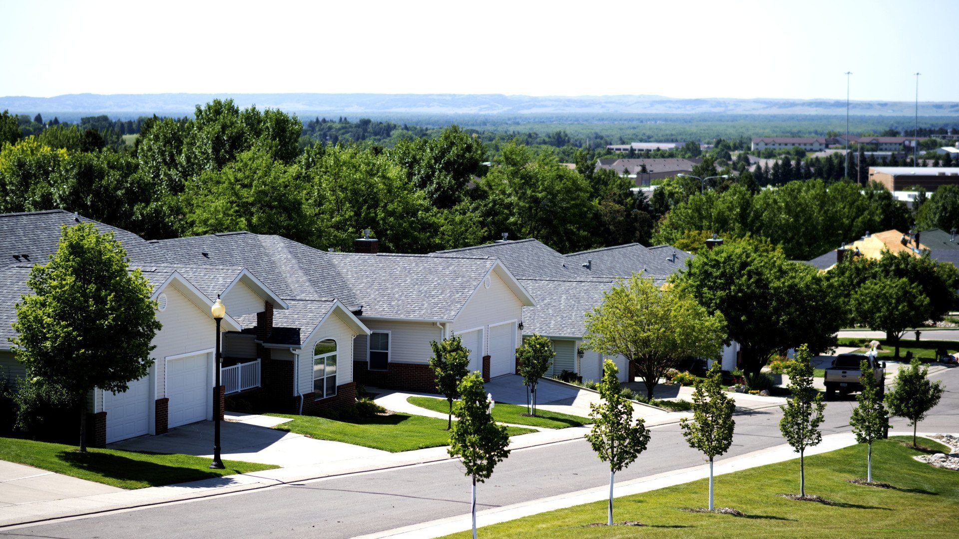 a row of houses in a residential area with trees in the background