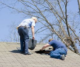 A guy inspecting a roof for damages