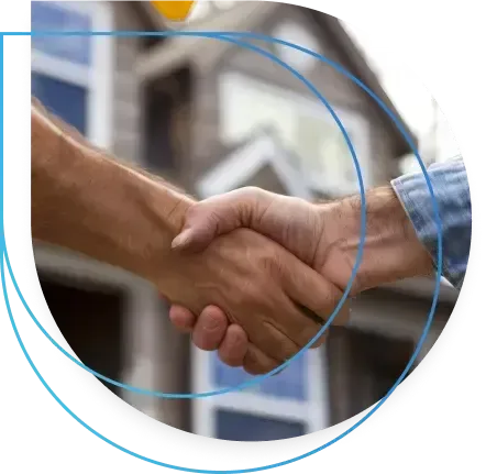 Two people shaking hands in front of a house. Two people shaking hands in front of a house.