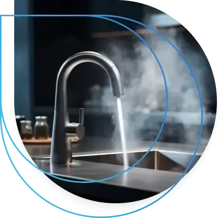 Kitchen faucet dispensing steaming water into a sink. Kitchen faucet dispensing steaming water into a sink.