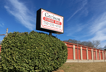 A sign displaying the Greison Storage Mart logo.