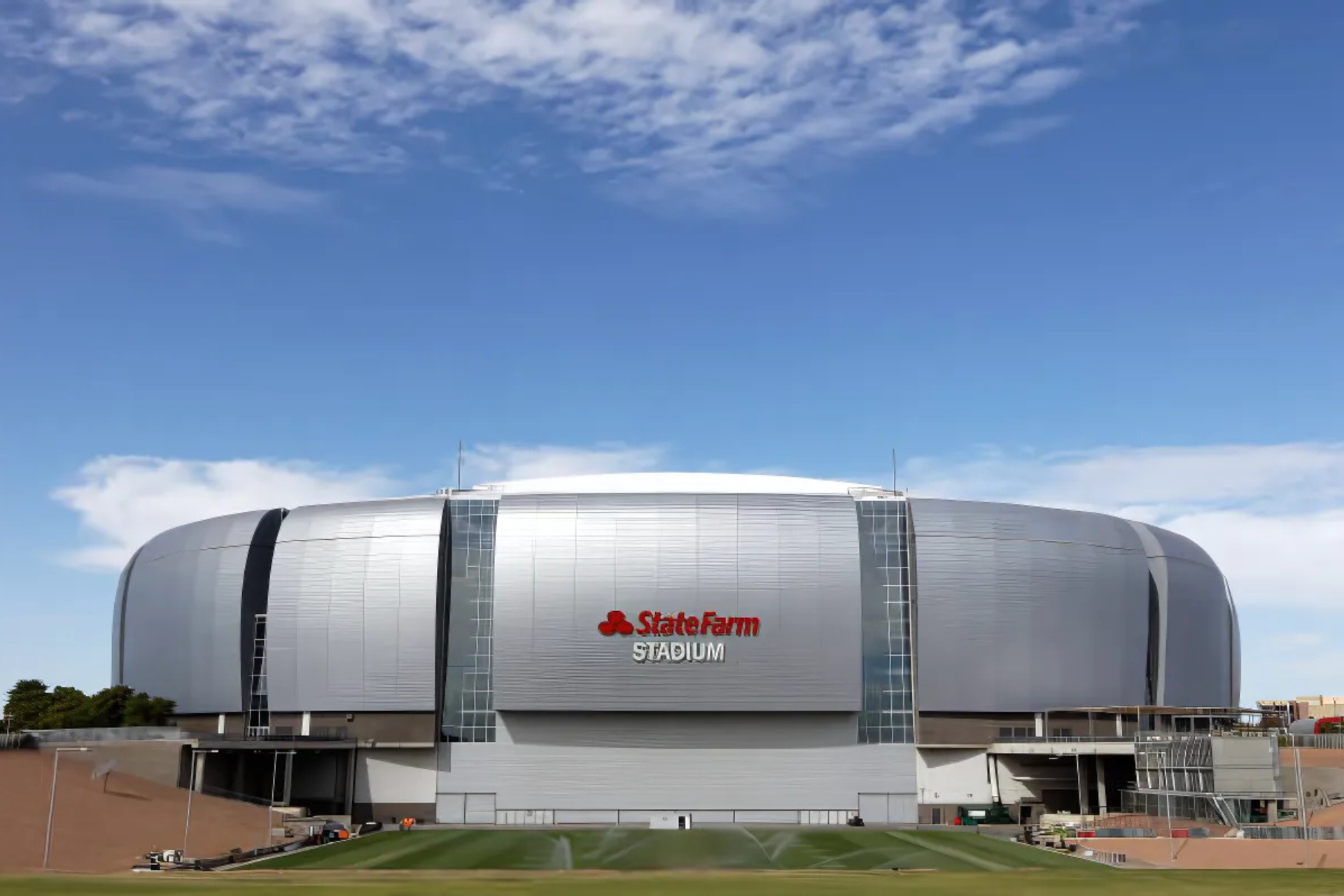 A large stadium with a blue sky in the background.