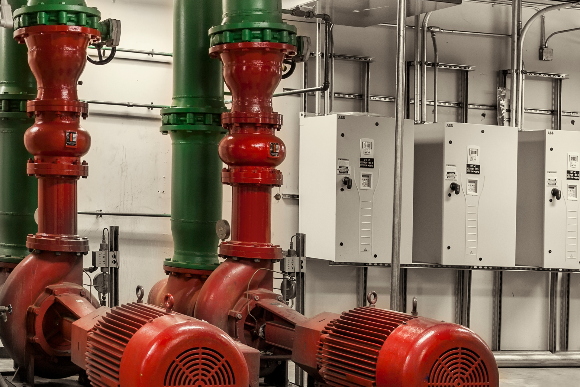 A row of red and green pipes in a room