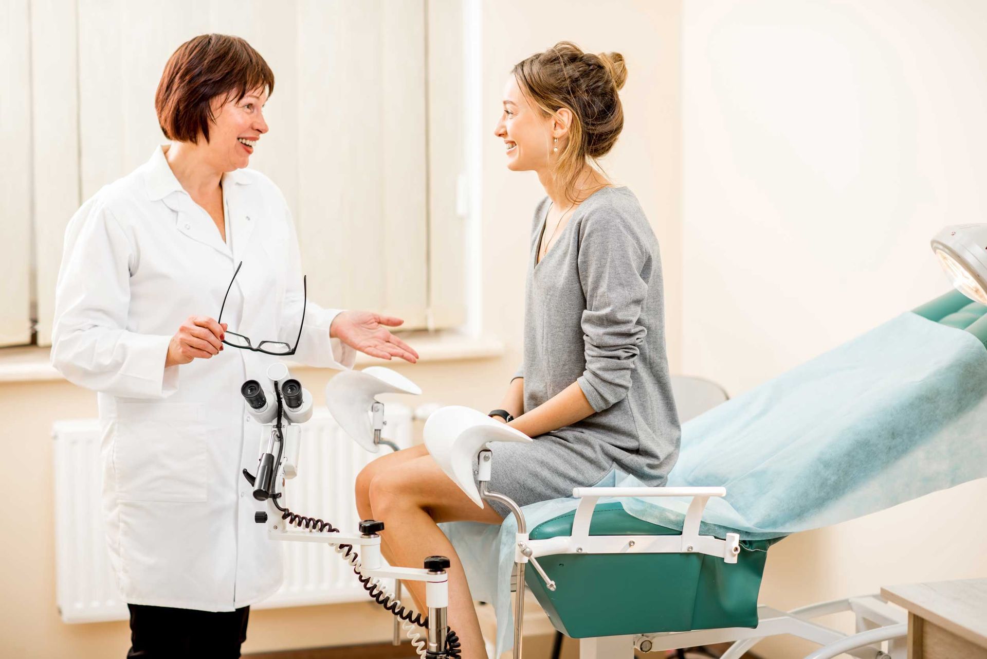 A doctor is talking to a woman in a gynecological consultation.