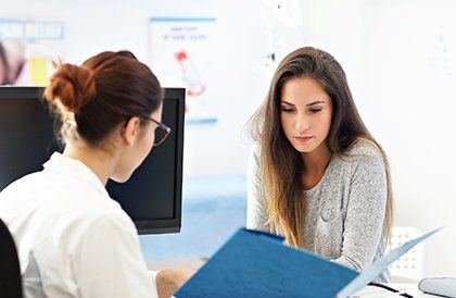 Woman Having a Visit at Female Doctor's Office — Key West, FL — Dr. Arthur J. Grizzle, M.D.