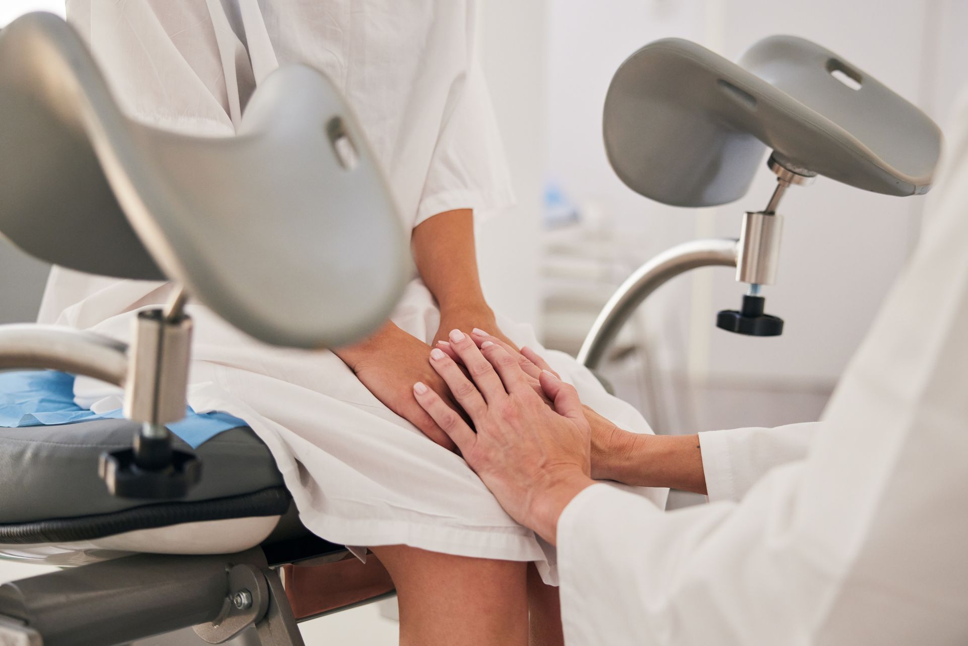A woman sitting in a gynecological examination chair.