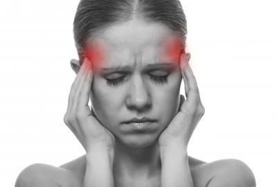 A Woman Experiencing a Headache — Anderson Family Chiropractic Health Centre in Mount Pleasant, QLD