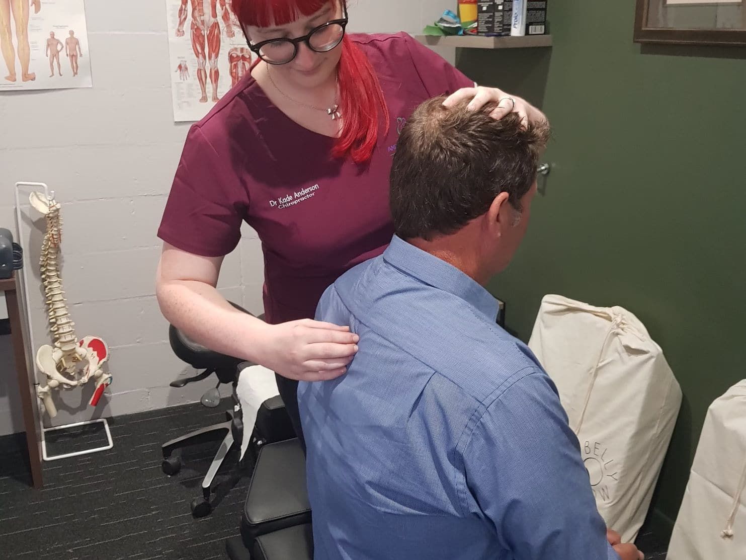 A Woman is Giving a Man a Massage in a Room — Anderson Family Chiropractic Health Centre in Mount Pleasant, QLD