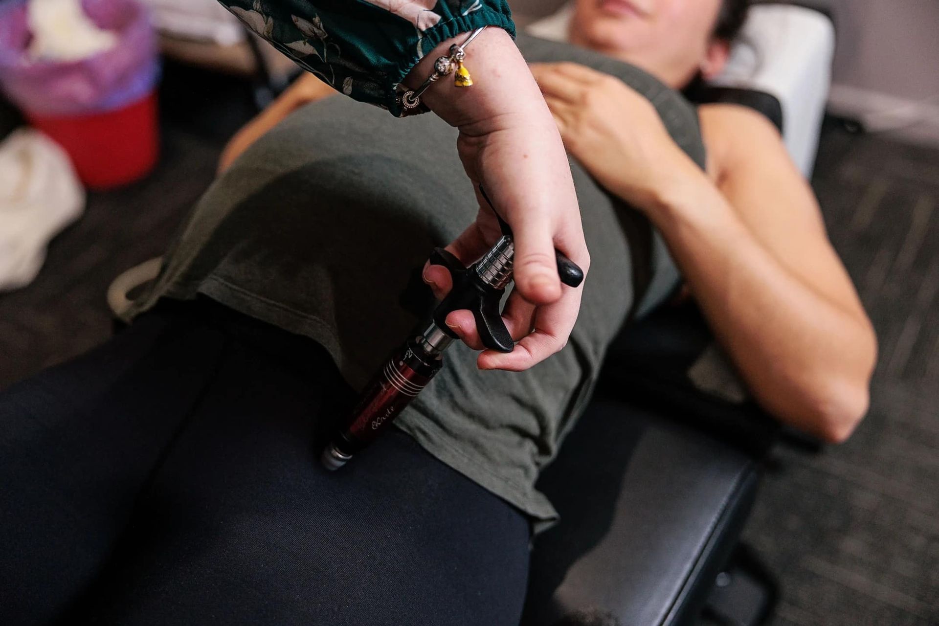 A Woman is Laying on a Bed Getting a Massage From a Doctor — Anderson Family Chiropractic Health Centre in Mount Pleasant, QLD
