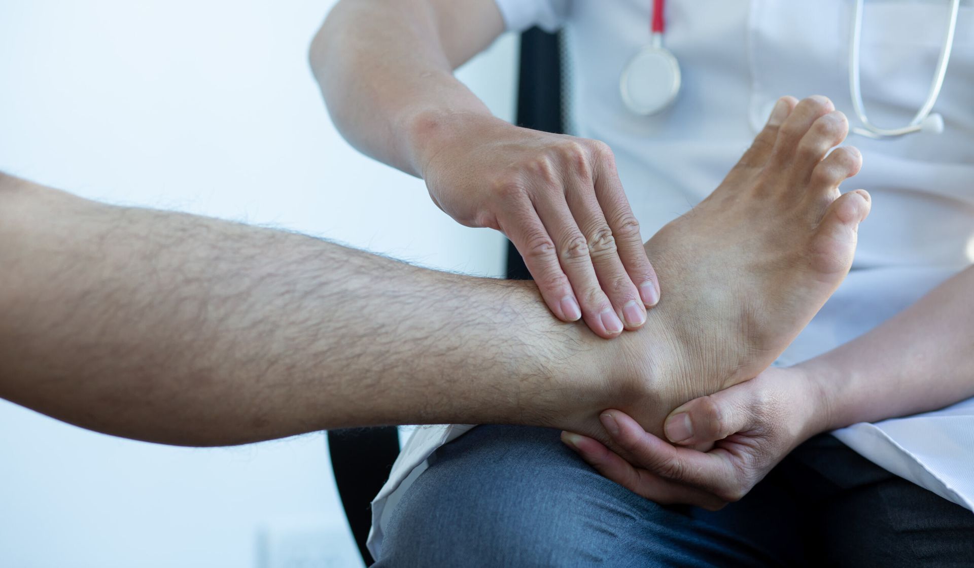 A Doctor is Examining a Patient 's Ankle — Anderson Family Chiropractic Health Centre in Mount Pleasant, QLD