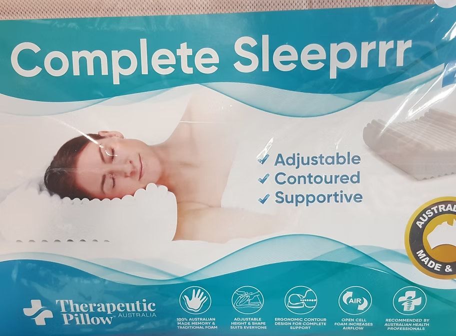 A Woman is Sleeping on a Therapeutic Pillow — Anderson Family Chiropractic Health Centre in Mount Pleasant, QLD