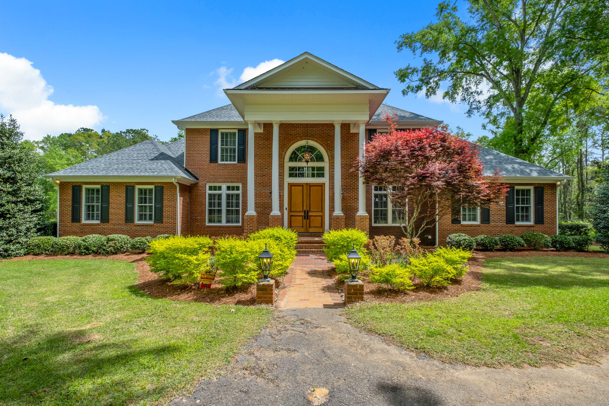 An aerial view of a lush green forest with a lot of trees.