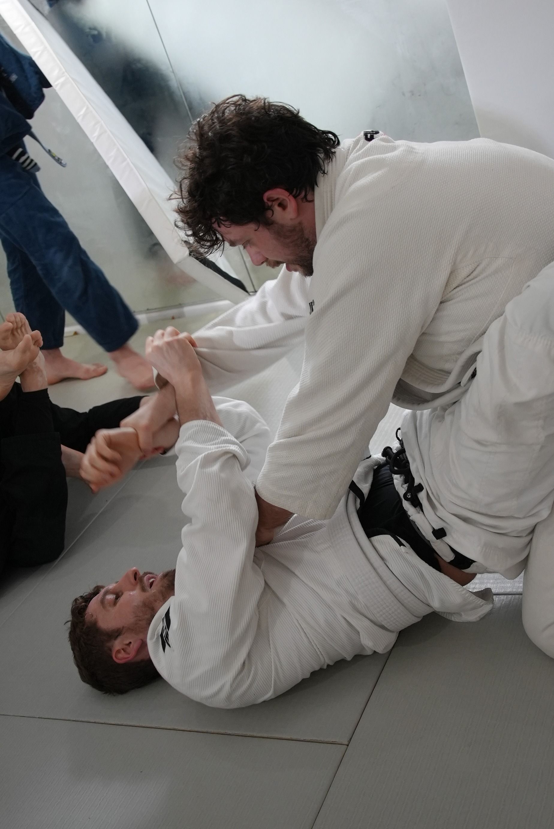 Adults drilling Brazilian Jiu-Jitsu techniques at Range Brazilian Jiu-Jitsu NYC in New York, building confidence and fitness.
