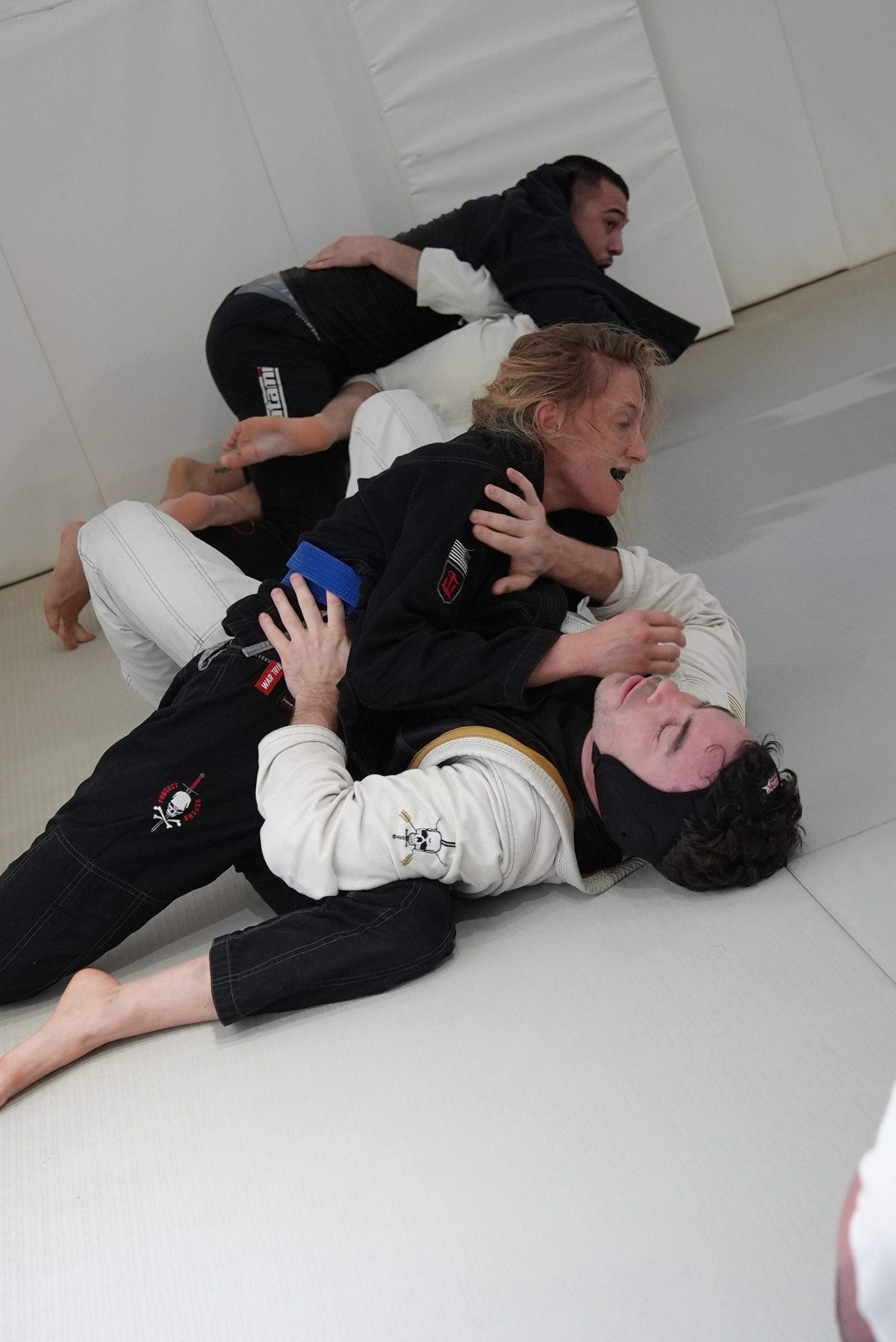 Adults training Brazilian Jiu-Jitsu at Range Brazilian Jiu-Jitsu NYC in New York, NY for functional fitness and stress relief.