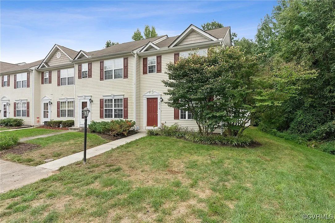 A white townhouse with red shutters in Richmond, VA and Chesterfield county virginia