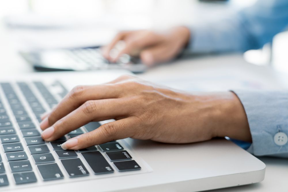 A Person is Typing on a Laptop Computer — Complete Computing Consultancy In Hervey Bay, QLD