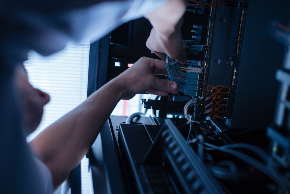 A Man is Working on a Computer in a Server Room — Complete Computing Consultancy In Maryborough, QLD