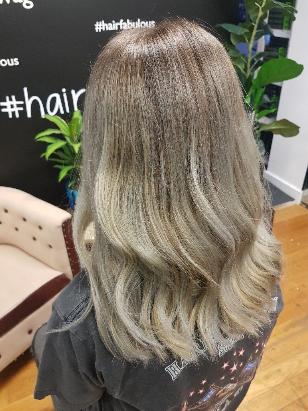 Female with long blonde hair in grey shirt.
