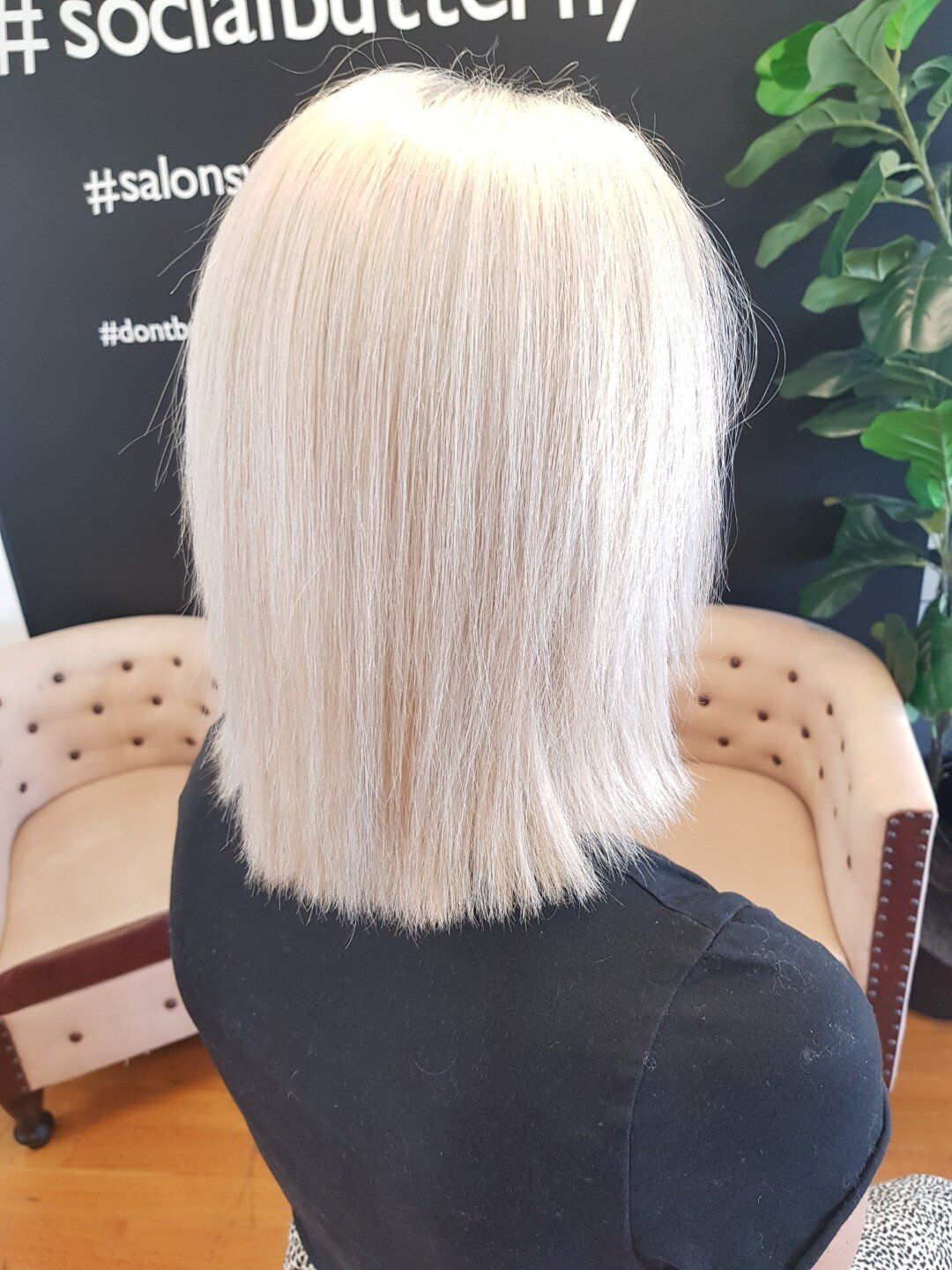 A woman with blonde hair sitting in a chair

