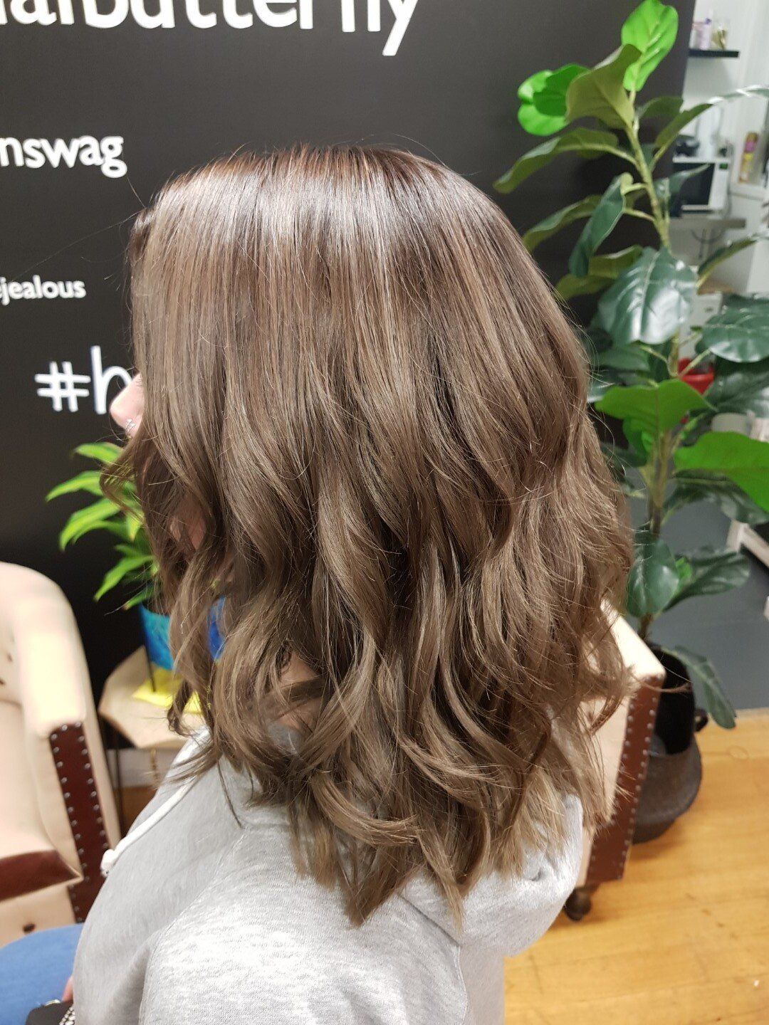 Hair showing natural brown roots with blonde ends.
