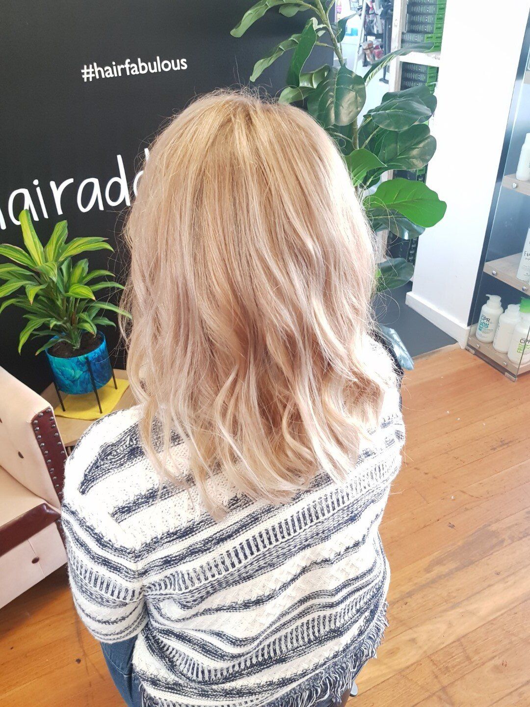 Back view of wavy hair with light blonde highlights.
