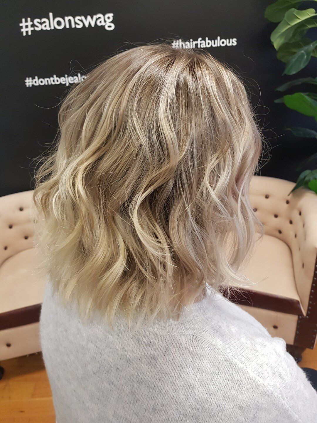 Rear view of blond hair with tight curls.
