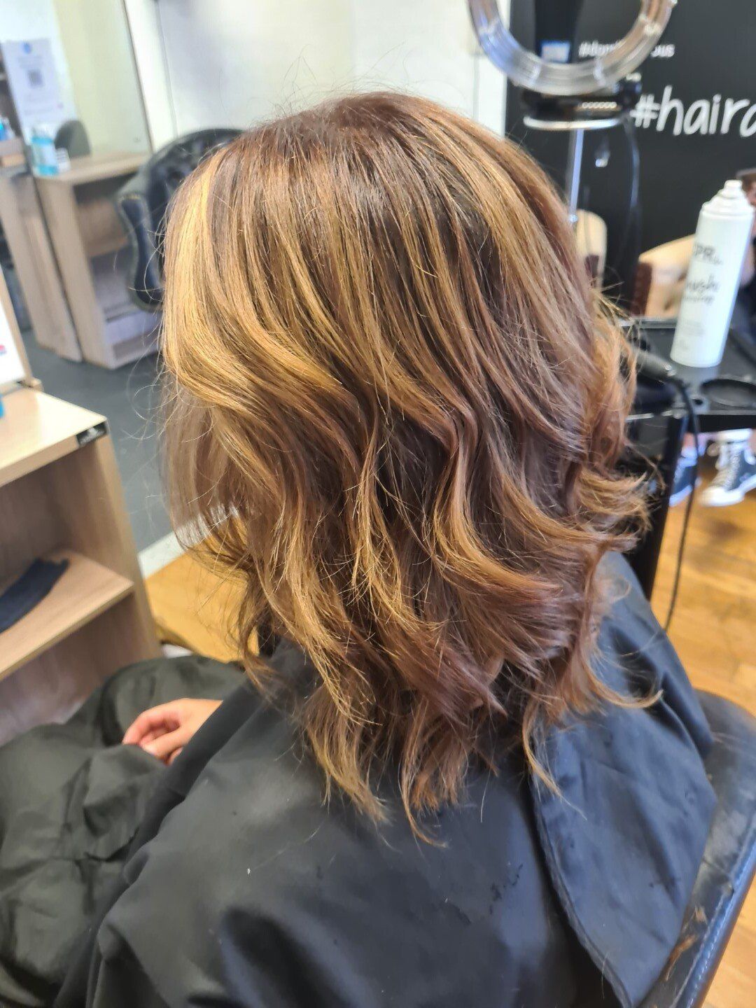 Close-up of dark hair with golden blonde highlights.
