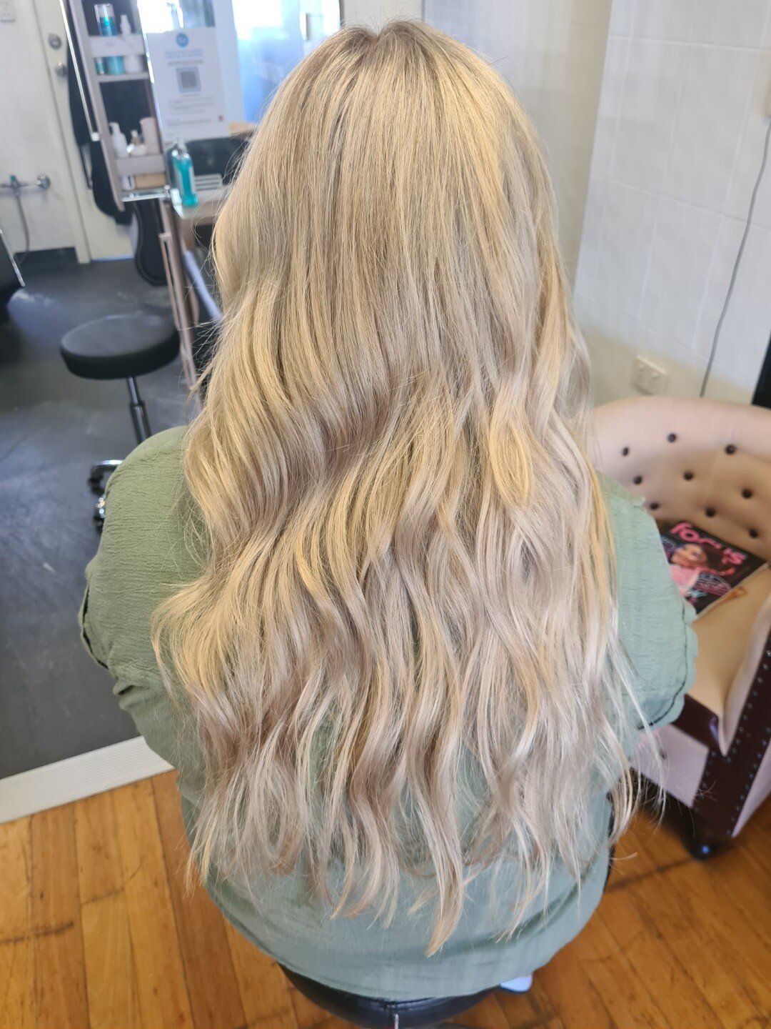 Back view of long wavy hair with blonde highlights.
