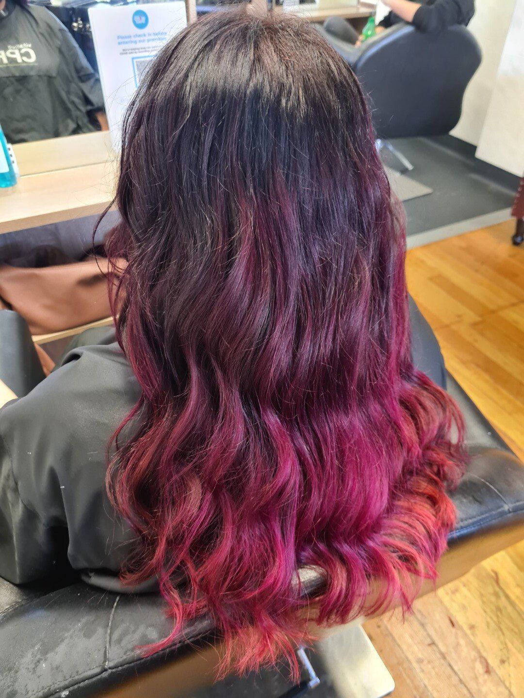 Rear view of hair with deep purple dye.

