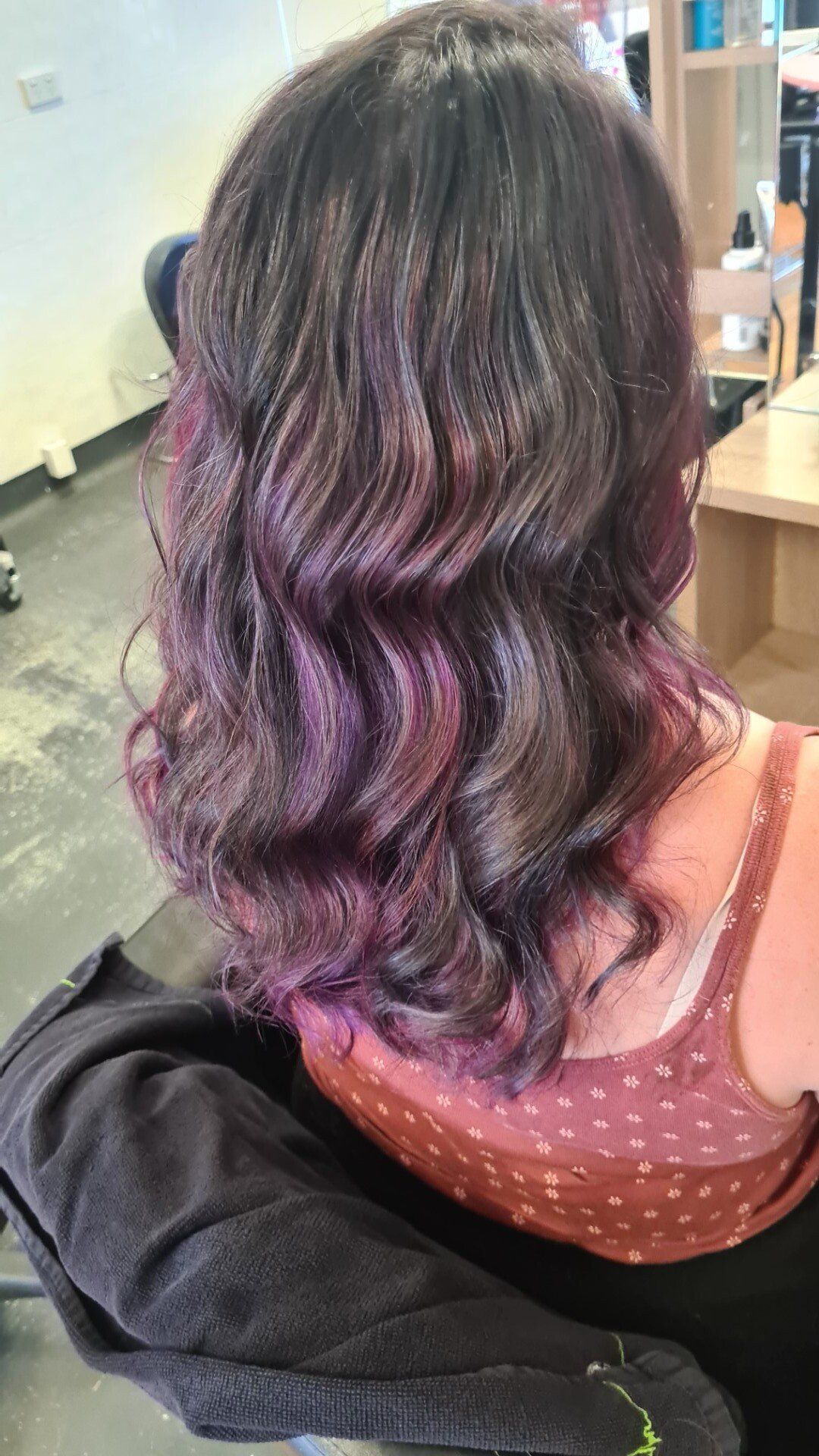 Rear view of hair with deep purple dye.
