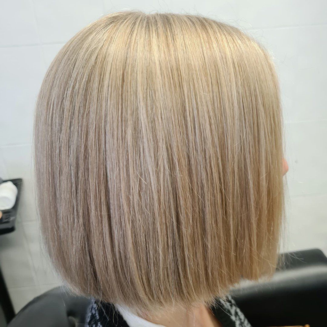 Side view of short, neatly styled blonde bob.

