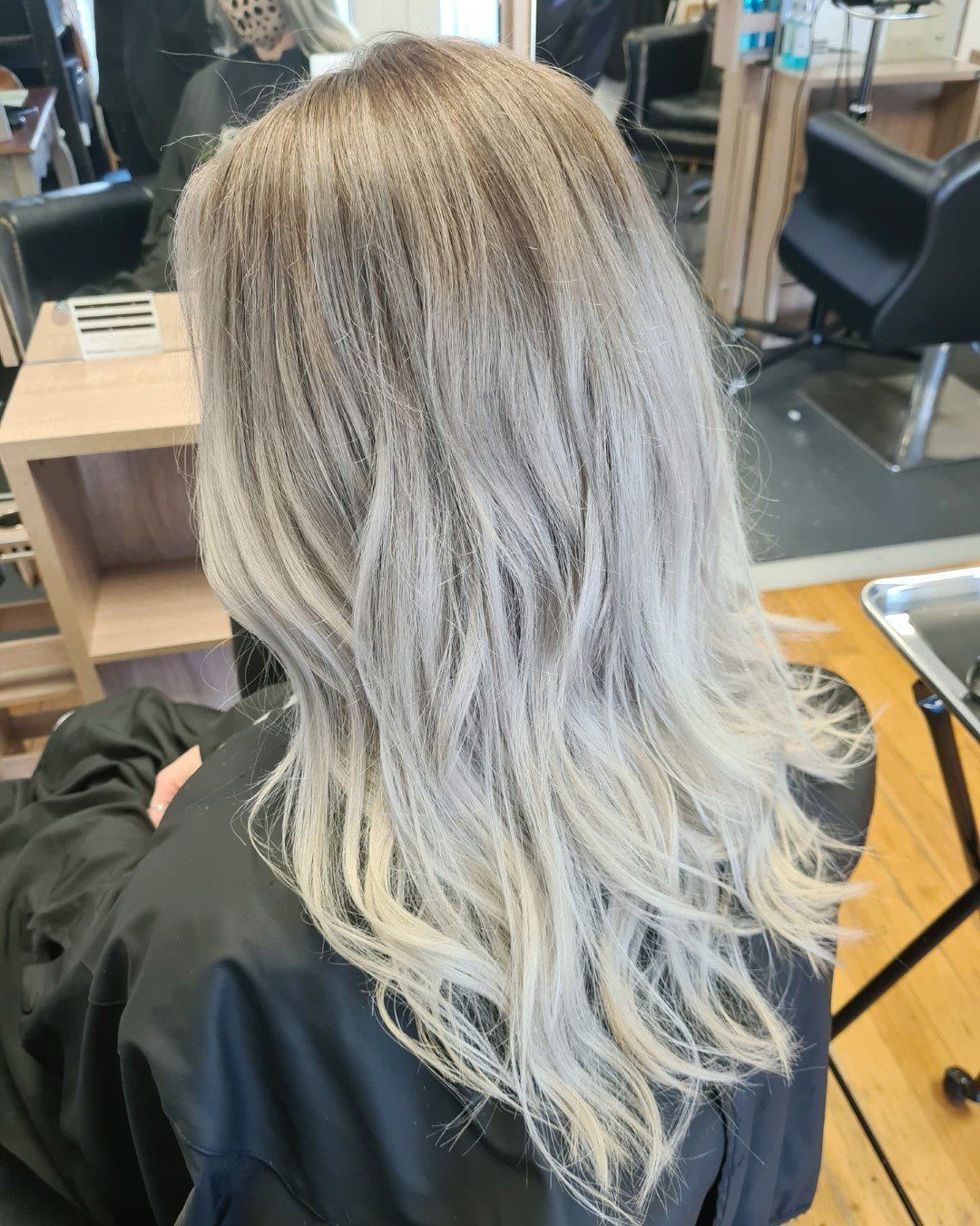 Close-up of blonde hair with dark roots showing.
