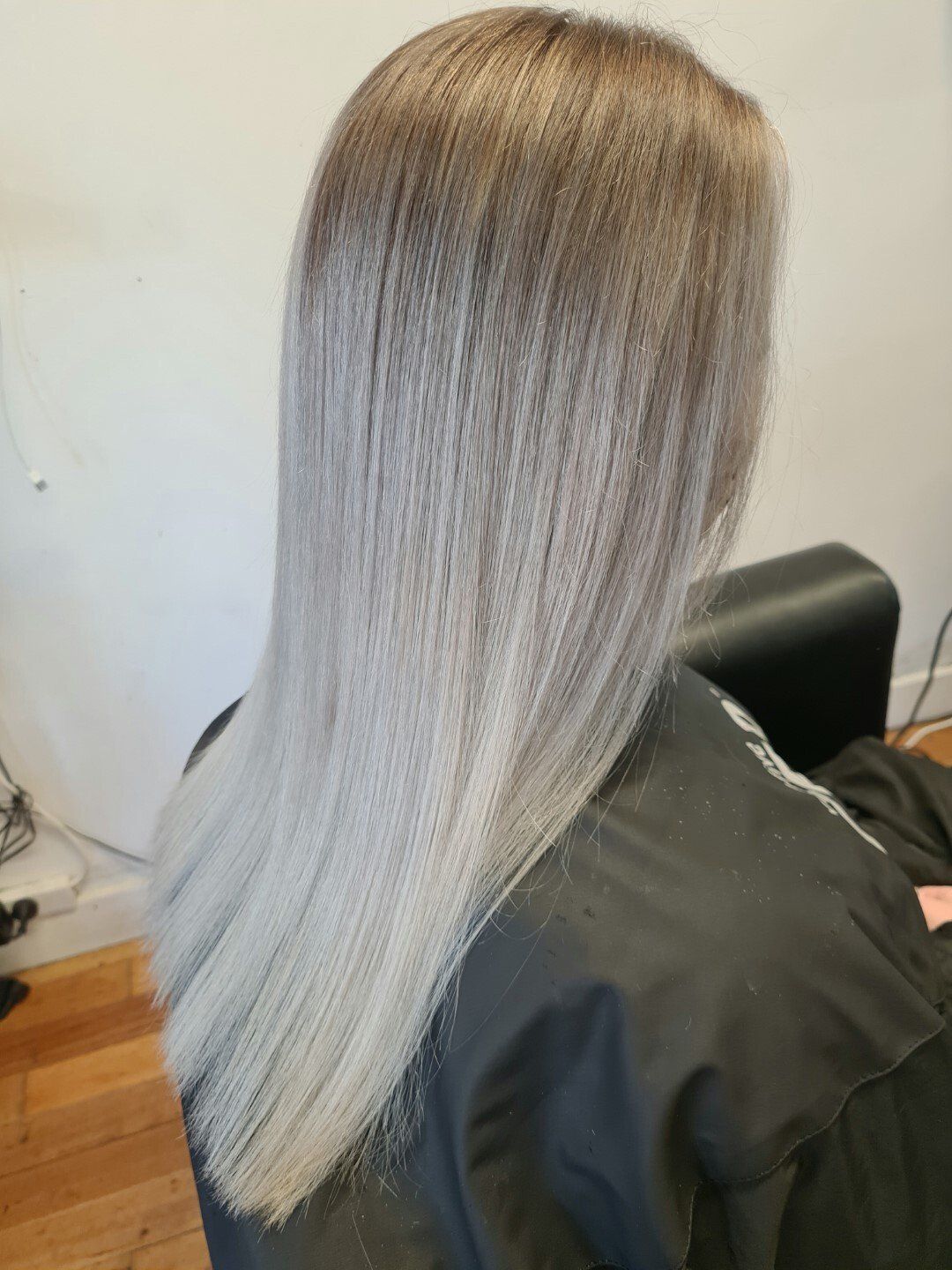 Back view of long blonde hair with natural waves.
