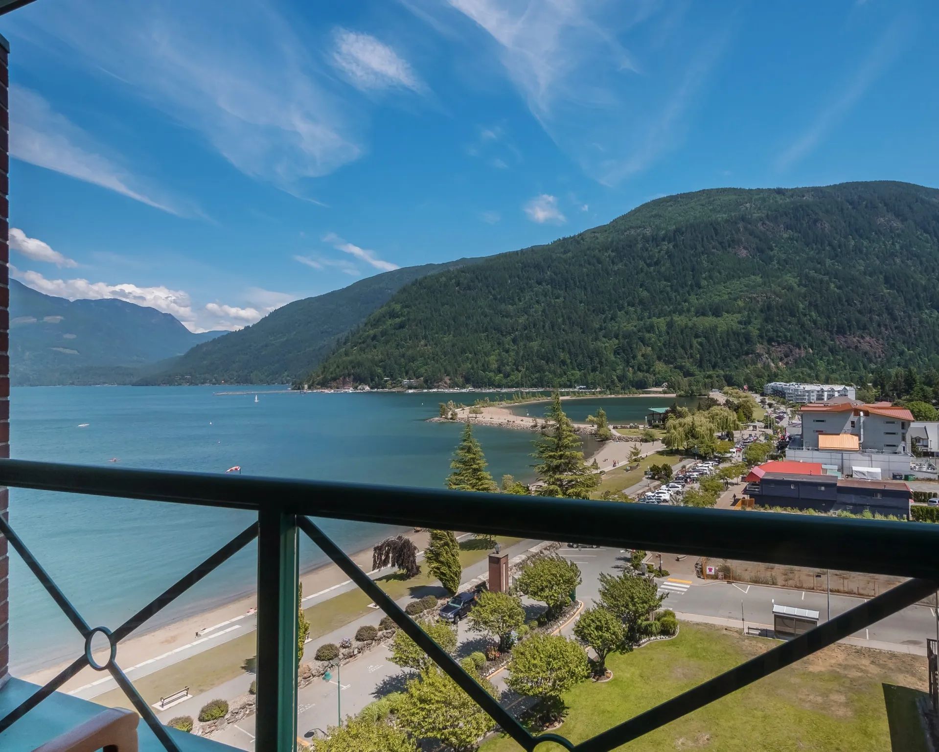 A balcony overlooking a lake with mountains in the background