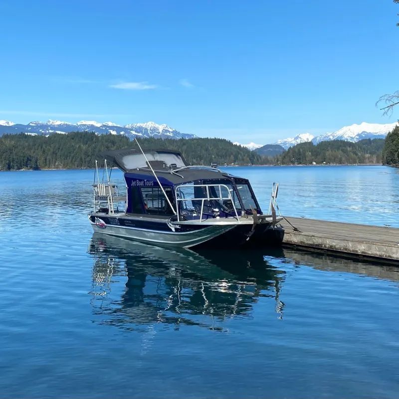 A boat is docked at a dock on a lake