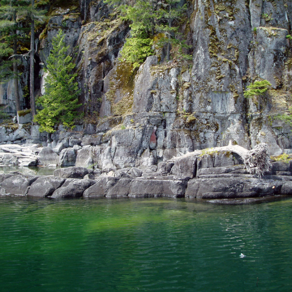 A large body of water surrounded by rocks and trees